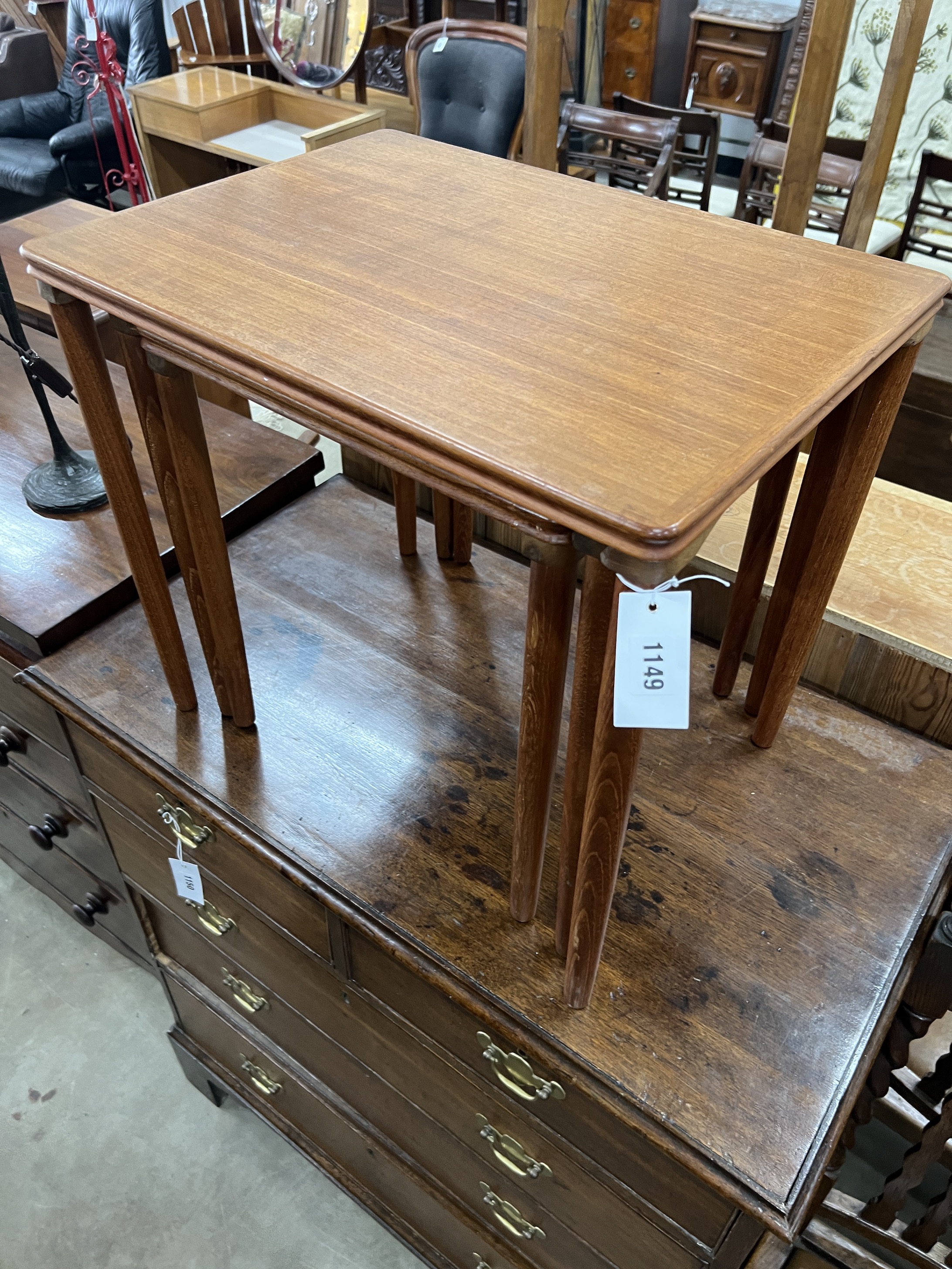 A nest of three rectangular teak mid century Danish style tea tables, width 55cm, depth 40cm, height 49cm